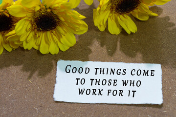 Wall Mural - Motivational quote on torn white paper with sunflower on wooden table background