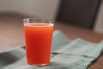 Organic grapefruit juice in tumbler glass on linen napkin