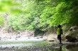 People strolling along the mountain stream. Fun. Green front blurring. Kakishokai k.