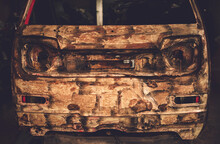 Front Of An Rusty Car In Garage