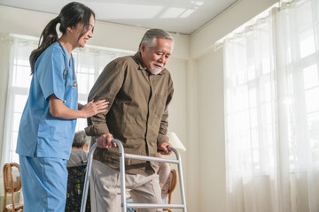 young asian female nurse care giver helping asian senior old man with mobility walker in living area of nursing home senior daycare center,Nurse take care elderly patient with cheerful concentrate