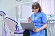 Online consultation, nurse help in clinic using laptop