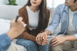 © Pormezz - couple relationship therapy with a counselor. Close Up hands of the psychologist take notes on a clipboard during a conversation with clients to find problems and solution.