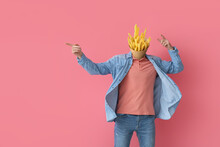 Man With Tasty French Fries Instead Of His Head Pointing At Something On Pink Background