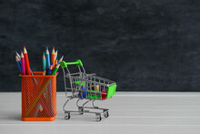Shopping Cart And Holder With Stationery On Table