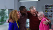 © TommyStockProject - Happy multiethnic team hug and smile in modern creative office