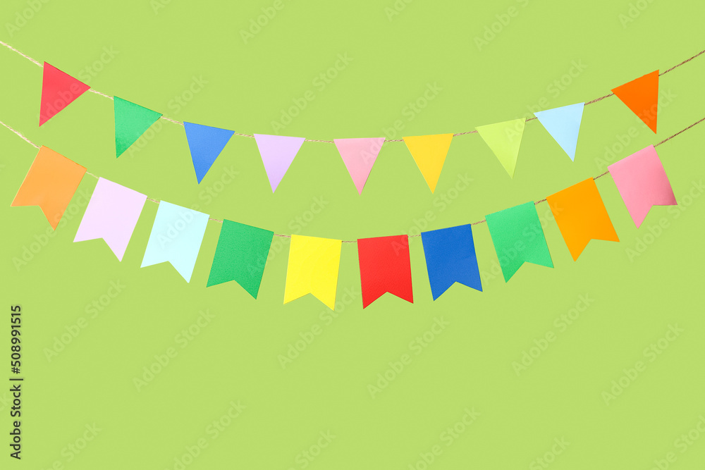 Colorful flags for Festa Junina on green background