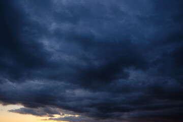 Wall Mural - Thunderstorm dramatic clouds during evening sunset.