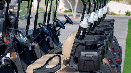 Wall Mural - A row of electric golf carts on a golf course.