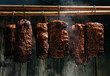 © Надія Коваль - Traditional method of smoking meat in smoke. Smoked ham, bacon, pork neck and sausages in a smokehouse