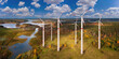 Environmentally friendly power plant. Power plant in forest with lakes. Windmills view from quadrocopter. Panoramic landscape with power plant. Getting electricity from wind. Green energy