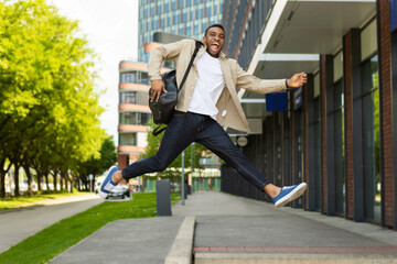 Young man jumping up high in the street.