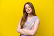 © luismolinero - Young caucasian woman isolated on yellow background with arms crossed and looking forward