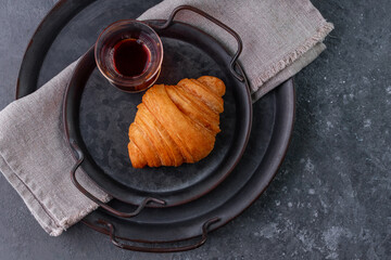 croissant on a vintage metal plate