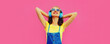 Leinwandbild Motiv Portrait of happy smiling young woman with headphones listening to music on pink background, blank copy space for advertising text