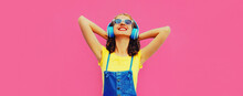 Portrait Of Happy Smiling Young Woman With Headphones Listening To Music On Pink Background, Blank Copy Space For Advertising Text