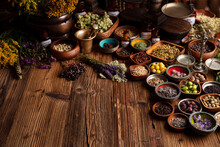  Natural Medicine Background. Assorted Dry Herbs In Bowls And Brass Mortar On Rustic Wooden Table.
