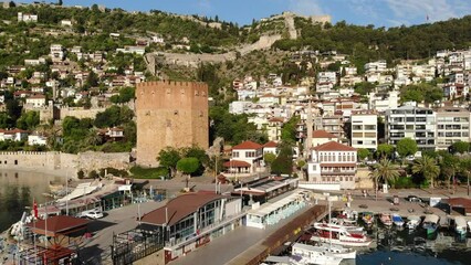 Wall Mural - Pier of Alanya with moored boats. View of Kizil Kule (Red Tower) and Castle of Alanya, Antalya Province, Turkey.