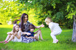 © alexkich - Young large family on a summer morning walk. Beautiful mother with children is playing in the park.