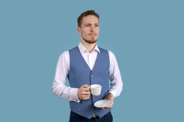 Attractive business young male elegant appearance manager boss drink morning coffee smell beautiful aroma formal dressing blue suit isolated blue color background