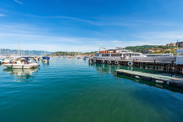 Wall Mural - Lerici port with the ferry boat station to the Cinque Terre (ferry terminal) and many boats moored, small town and tourist resort on the coast of the Gulf of La Spezia, Liguria, Italy, Europe.