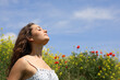 © Antonioguillem - Woman breathing fresh air in a flowers field
