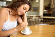 © Antonioguillem - Pensive woman stirring coffee sitting in a restaurant