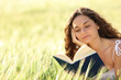 © Antonioguillem - Woman reading a paper book in a wheat field