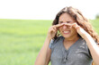© Antonioguillem - Woman scratching eyes in a wheat field