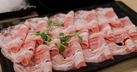 Fresh raw slice of pork meat for shabu shabu at restaurant