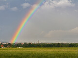 Fototapeta Tęcza - City Ceske Budejovice with storm cloud sky, rainbow and barley filed. Czech republic