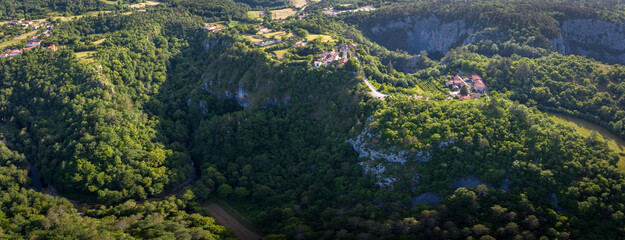 Wall Mural - Panoramic aerial view of site Skocjanske Jame (Skocjan caves) with village Skocjan and deep gorge of Reka river, Slovenia