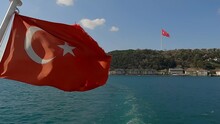 The Turkish Flag Flutters In The Wind. Turkish Flag On A Ship In The Bosphorus. Turkish Flag On Sky Background