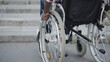 © Synthex - Black man with disability facing stairs, challenges of wheelchair, accessibility