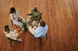 © pressmaster - Young black man talking to one of patients attending psychotherapy course while sitting on chair in front of her during session