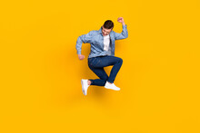 Full Size Profile Side Photo Of Young Man Jump Up Celebrate Luck Fists Hands Triumph Isolated Over Yellow Color Background