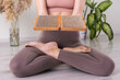 yogi woman holding sadhu board for Nail standing practice yoga meditation foot massage 