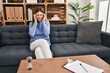 © Krakenimages.com - Young brunette woman at consultation office with hand on head for pain in head because stress. suffering migraine.