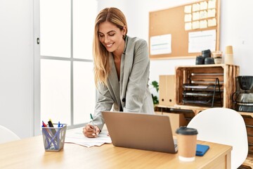 Young caucasian businesswoman smiling happy working at the office.