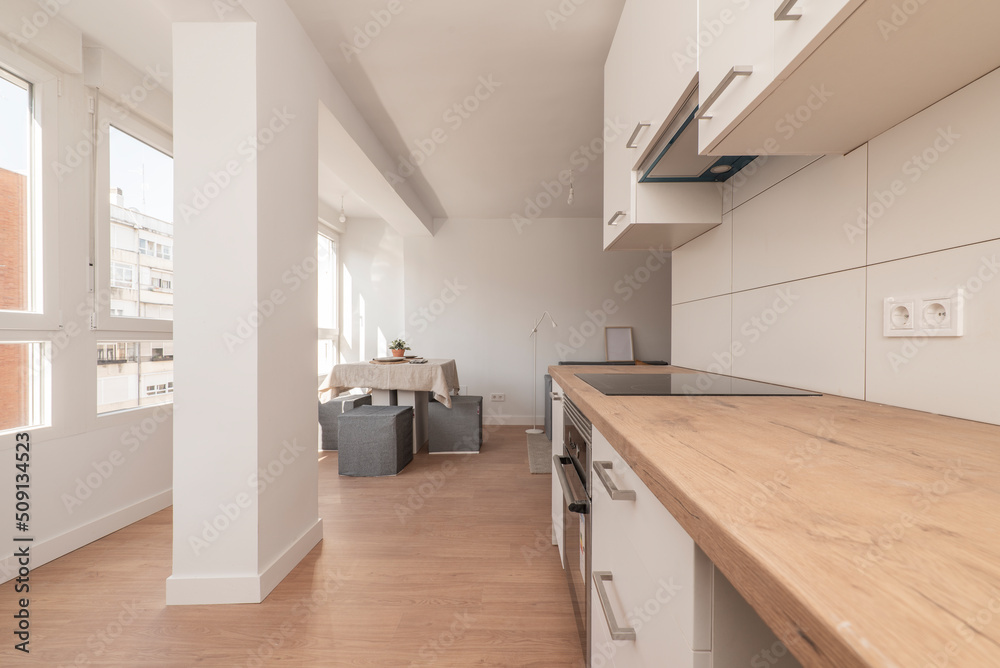 new open plan kitchen with wood counters, white cabinets and stainless ...