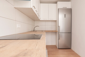 Wall Mural - new kitchen with wooden countertops, white cabinets and stainless steel appliances