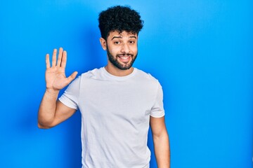 Sticker - Young arab man with beard wearing casual white t shirt waiving saying hello happy and smiling, friendly welcome gesture