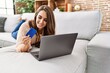 © Krakenimages.com - Young hispanic woman smiling confident using laptop and credit card at home