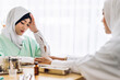 © Art_Photo - Muslim asian woman doctor service help support discussing and consulting talk to muslim woman patient at meeting health medical care express trust concept in hospital.healthcare and medicine