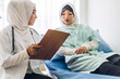 © Art_Photo - Muslim asian woman doctor service help support discussing and consulting talk to muslim woman patient at meeting health medical care express trust concept in hospital.healthcare and medicine