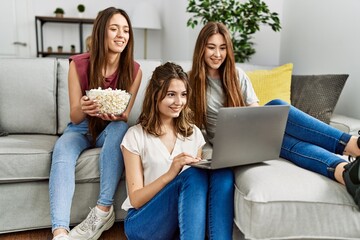 Canvas Print - Three young hispanic woman smiling happy watching film using laptop at home.