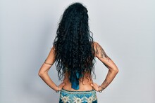 Young Woman Wearing Bindi And Traditional Belly Dance Clothes Standing Backwards Looking Away With Arms On Body