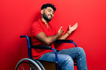 Poster - Arab man with beard sitting on wheelchair inviting to enter smiling natural with open hand