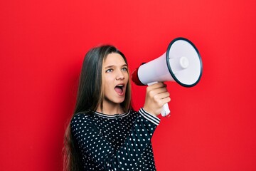 Wall Mural - Young teenager girl shouthing and screaming with megaphone