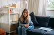 © cherryandbees - teenager caucasian girl sitting on sofa and looking at camera